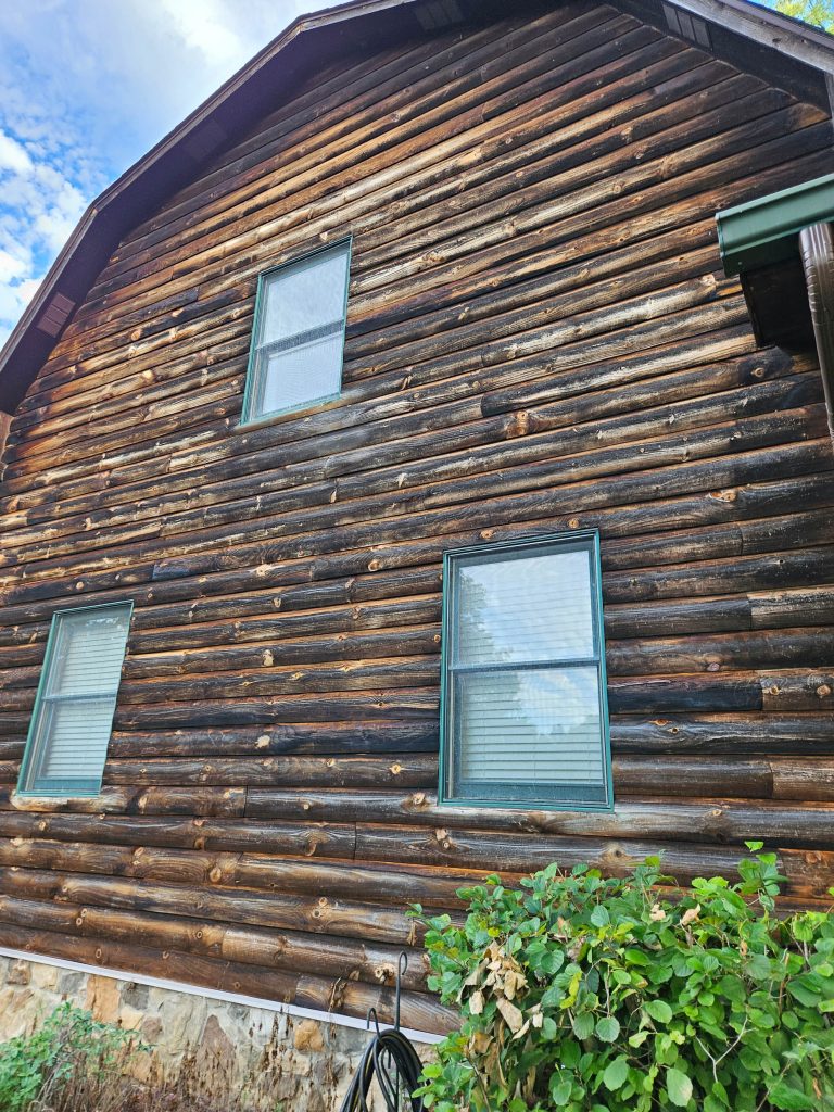 weathered logs on log cabin. sandblasting needed for log home