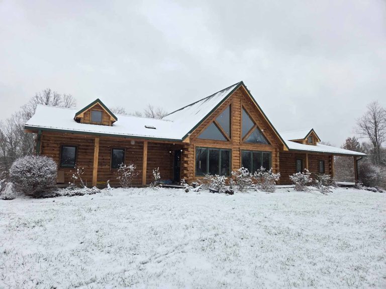 snowy log cabin home with hazelnut stain color