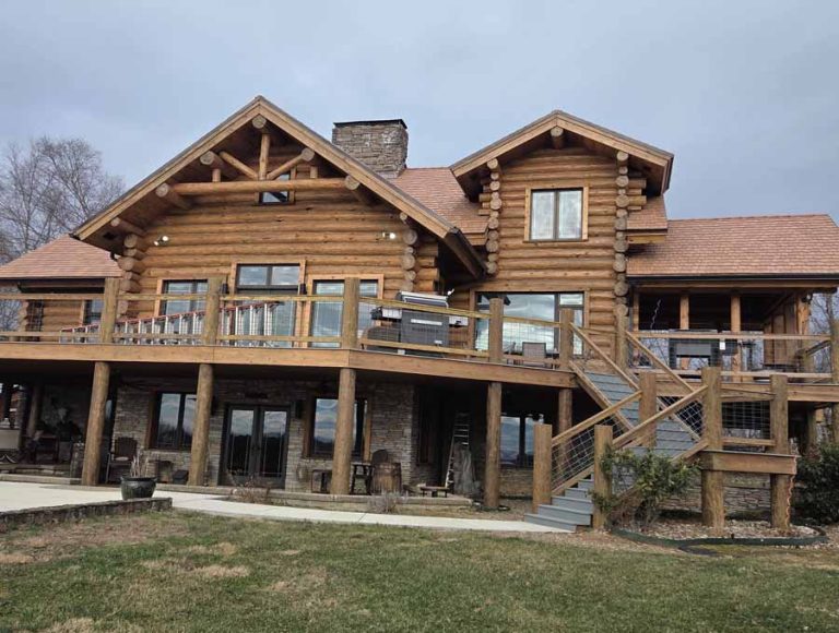 porch view of a log cabin home with a natural stain color